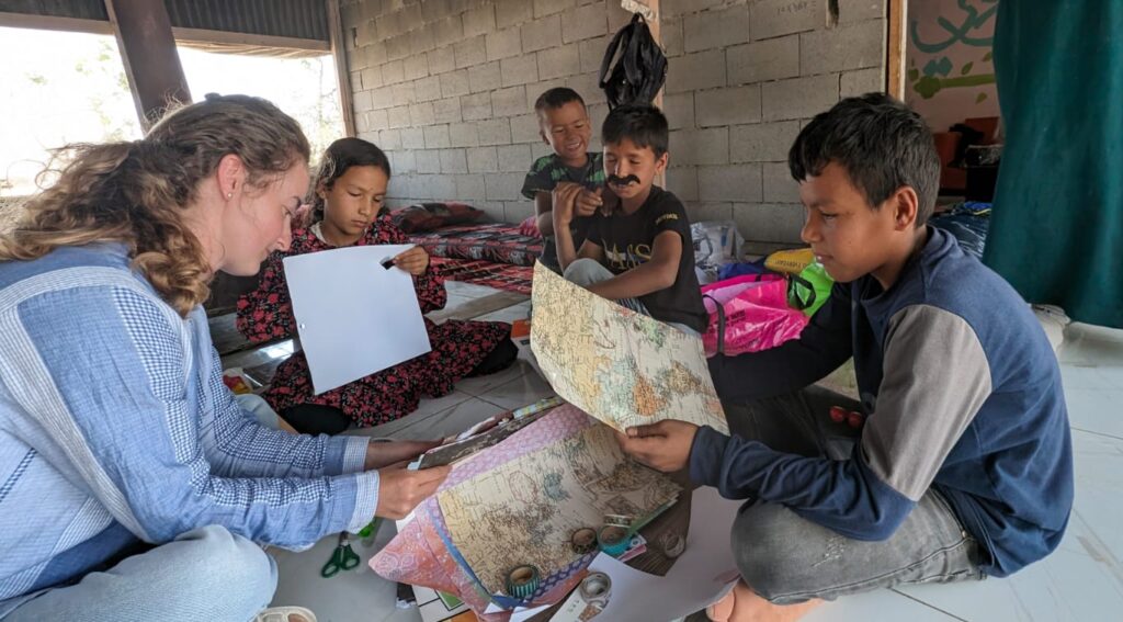 Member of the JLIC Tel Aviv Community reading and engaging with a few of the Husseini children.