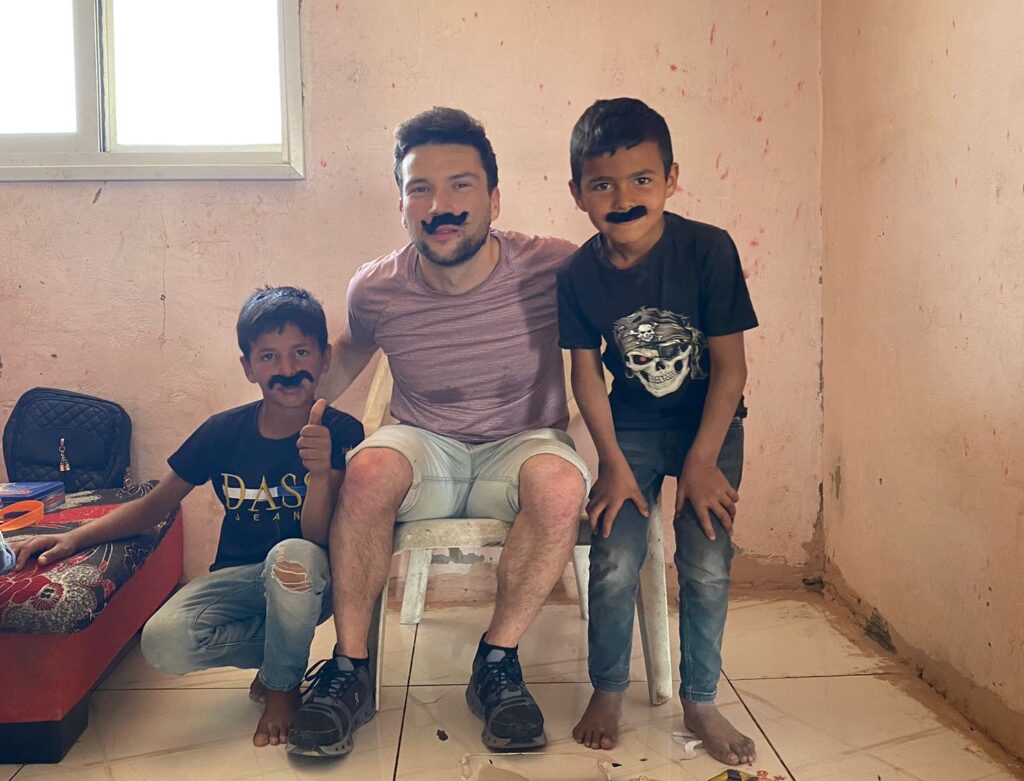 Member of the JLIC Tel Aviv Community planing with two of the Husseini boys.